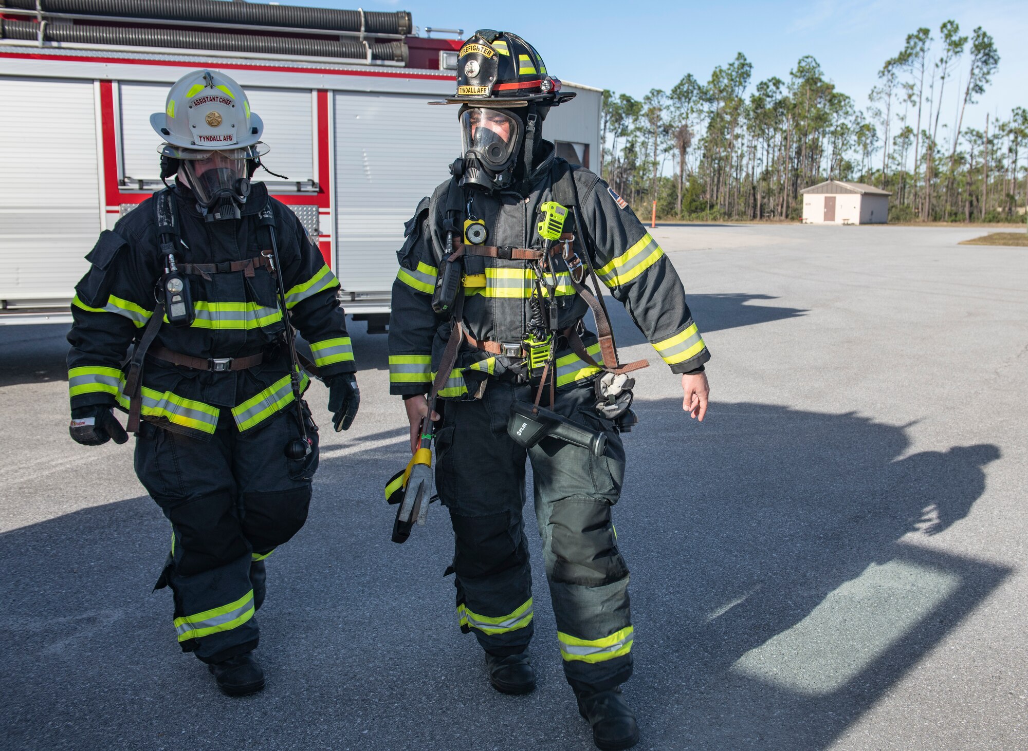 U.S. Air Force Col. Brian Laidlaw, 325th Fighter Wing commander (left), walks with U.S. Air Force Senior Airman Christian Gosnell, 325th Civil Engineer Squadron driver operator (right), to a simulated burning building exercise at Tyndall Air Force Base, Fla., Dec. 20, 2019. Laidlaw joined Gosnell and the 325th CES fire team to experience fire fighting first hand. (U.S. Air Force photo by Senior Airman Stefan Alvarez)