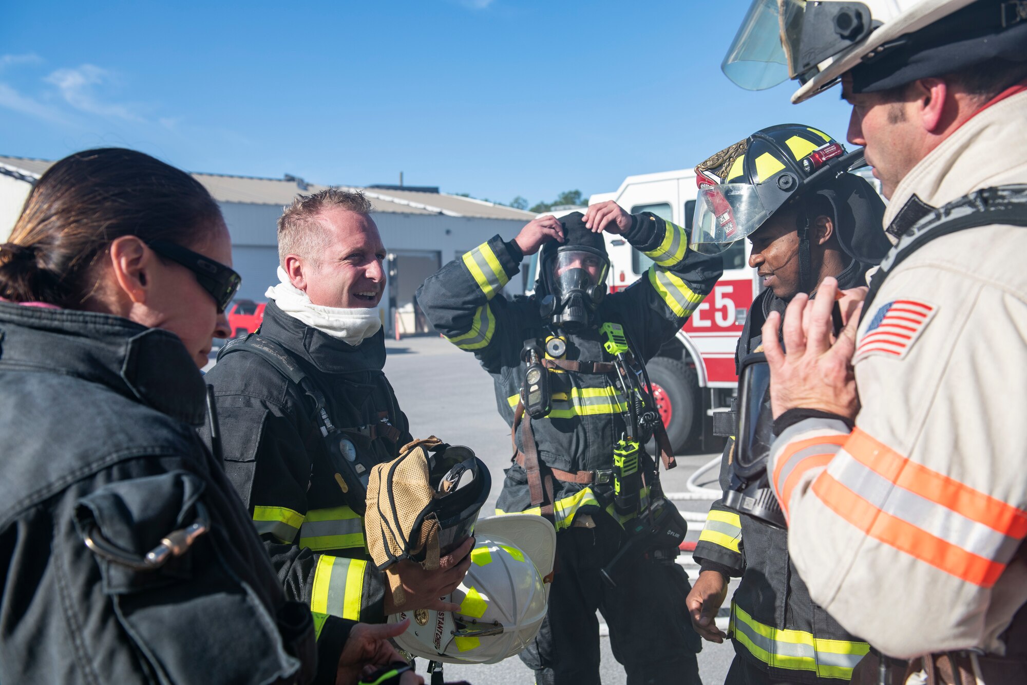 U.S. Air Force Col. Brian Laidlaw, 325th Fighter Wing commander (second from right), shares his experience with 325th Civil Engineer Squadron fire fighters after a simulated burning building exercise at Tyndall Air Force Base, Fla., Dec. 20, 2019. Laidlaw joined select 325th CES Airmen to experience fire fighting first hand. (U.S. Air Force photo by Senior Airman Stefan Alvarez)
