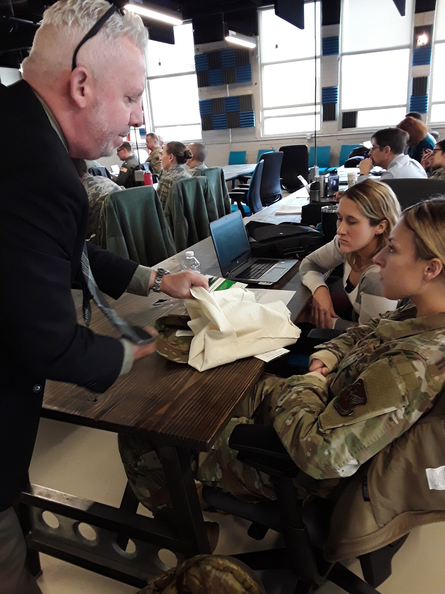 Second Lt. Dominique O’Brien and Dr. Jennifer Martin, both with the Air Force Research Laboratory’s 711th Human Performance Wing, look at a fabric to contain sensors shown by an industry participant during the first Physiological Episodes Mitigation Technology Summit and Industry Day in Dayton, Ohio, Dec. 17-18.