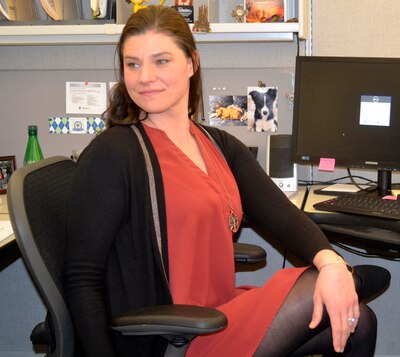 Megan Ward, a purchasing agent in Defense Logistics Agency Troop Support’s Industrial Hardware supply chain, certified holistic health consultant, health coach, yoga instructor and personal trainer, demonstrates a stretch from a standard office chair Jan. 2, 2020, in Philadelphia.