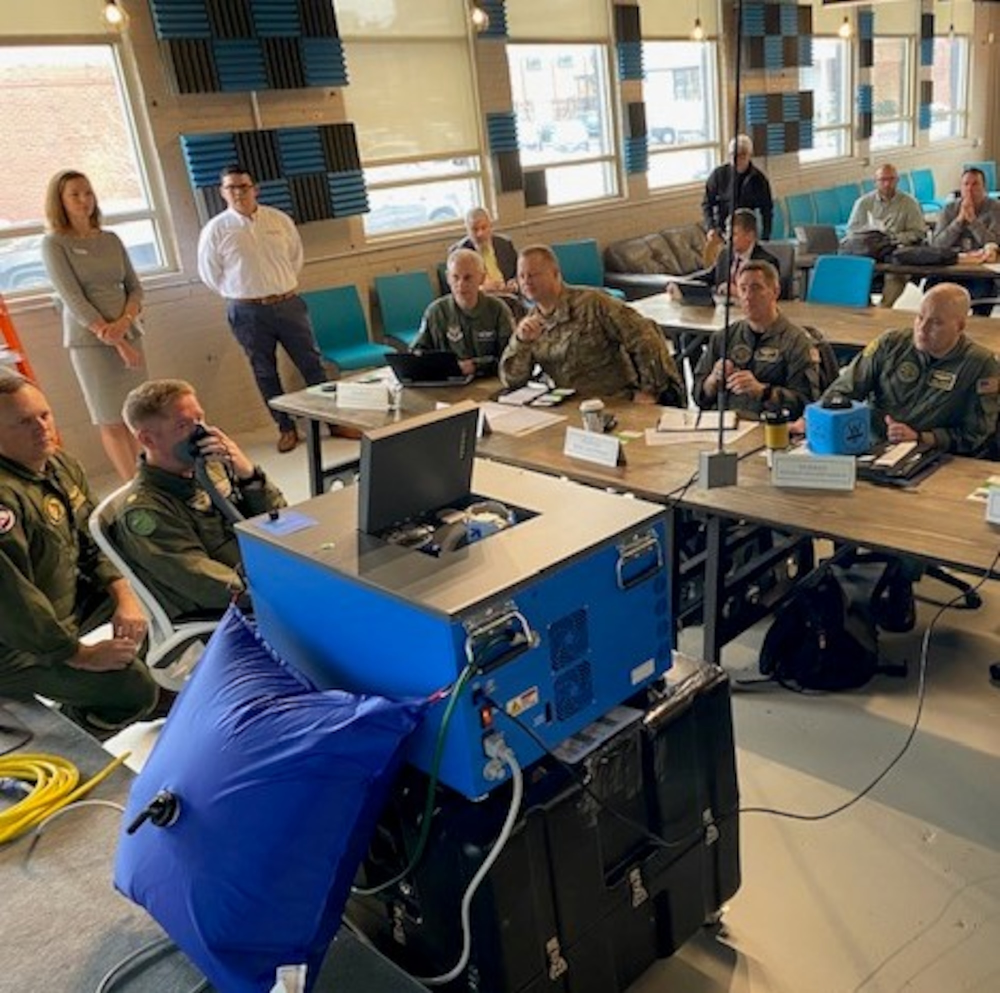 Air Force and Navy officials watch a demonstration during the inaugural Physiological Episodes Mitigation Technology Summit and Industry Day in Dayton, Ohio, Dec. 17-18.