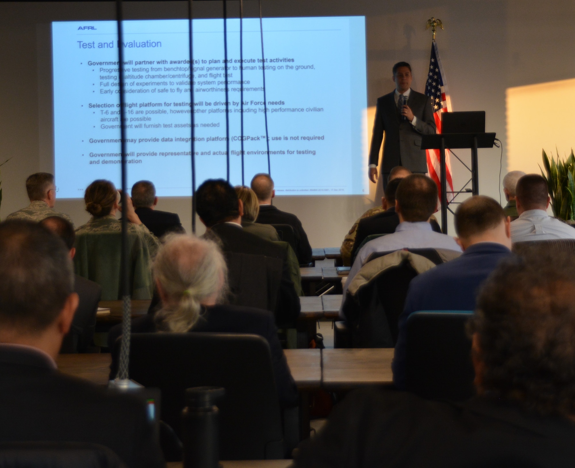 Dr. James Christensen, research psychologist with the Air Force Research Laboratory’s 711th Human Performance Wing, gives a briefing Dec. 18 during the inaugural Physiological Episodes Mitigation Technology Summit and Industry Day in Dayton, Ohio.