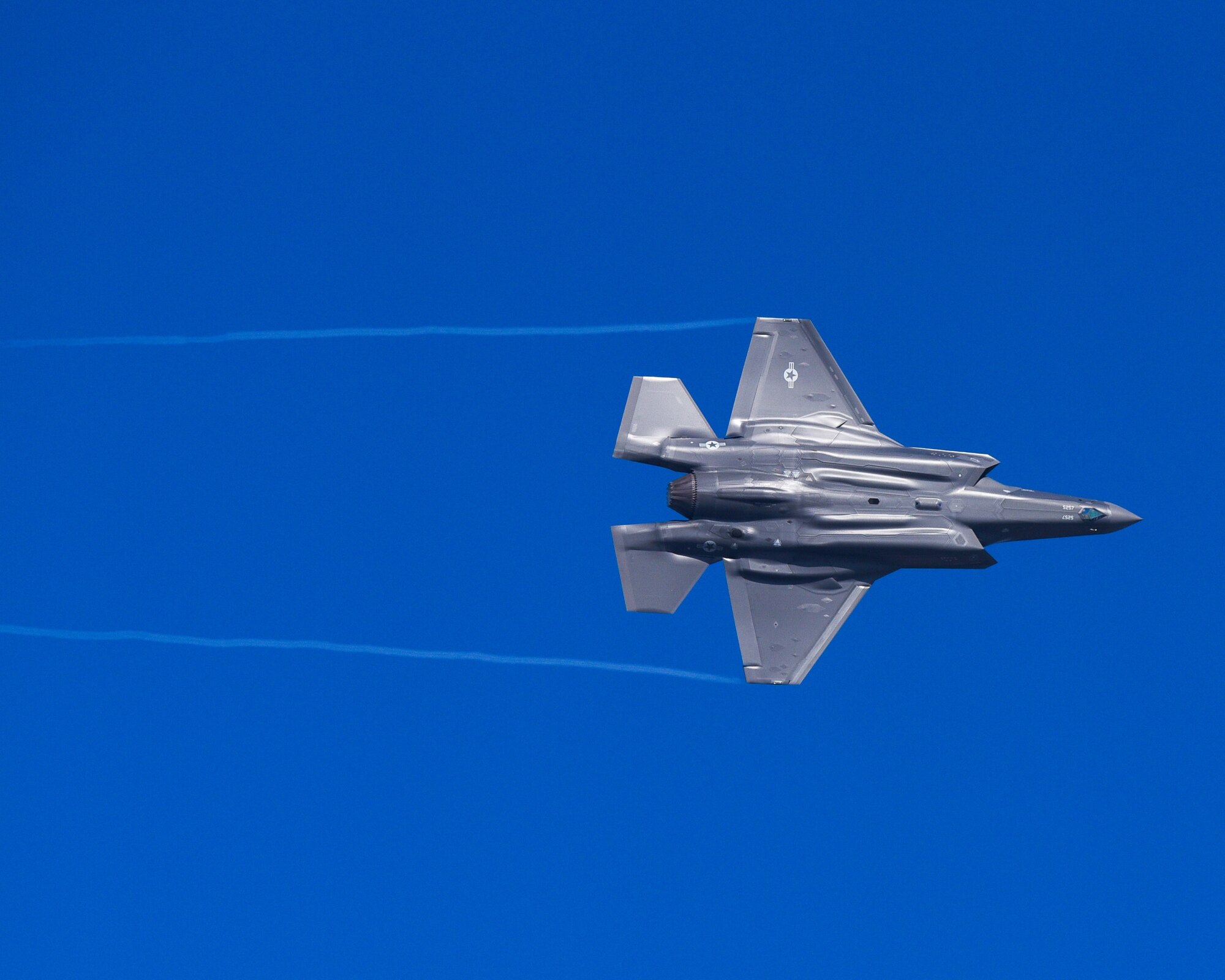 The underbelly of an F-35A Lightning II during flight.