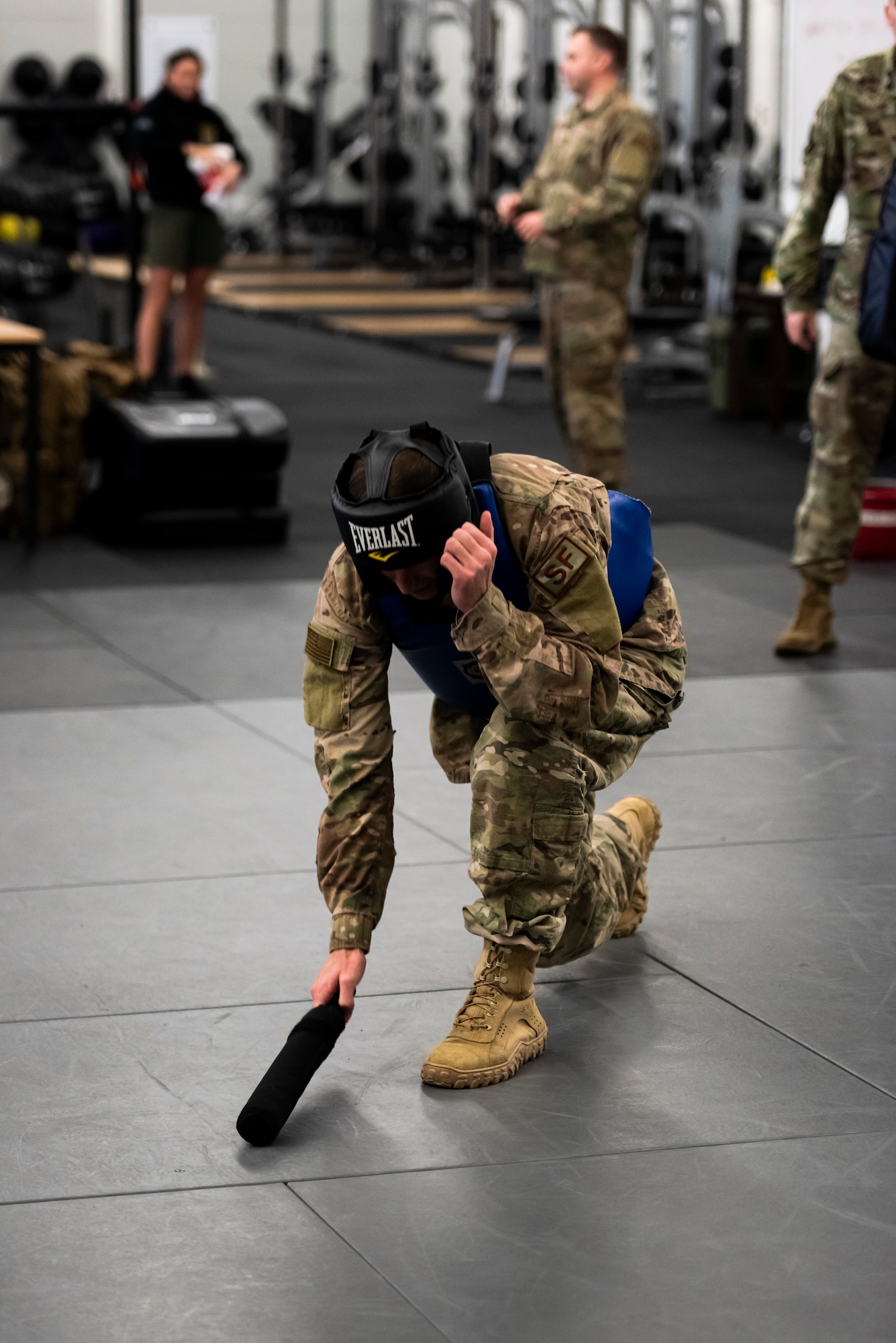 A U.S. Air Force Airman conducts the proper technique of picking up a baton to begin sparring during a Leader Led Training Course at Ramstein Air Base, Germany, Dec. 7, 2019. The Air Force designed the LLTC to teach Airmen how to use and train their own squadrons on what they learned. (U.S. Air Force photo by Staff Sgt. Devin Nothstine)