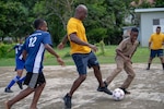 Sailors assigned to the Freedom-variant littoral combat ship USS Detroit (LCS 7) play soccer with students during a community relations event at Ocho Rios Primary School.