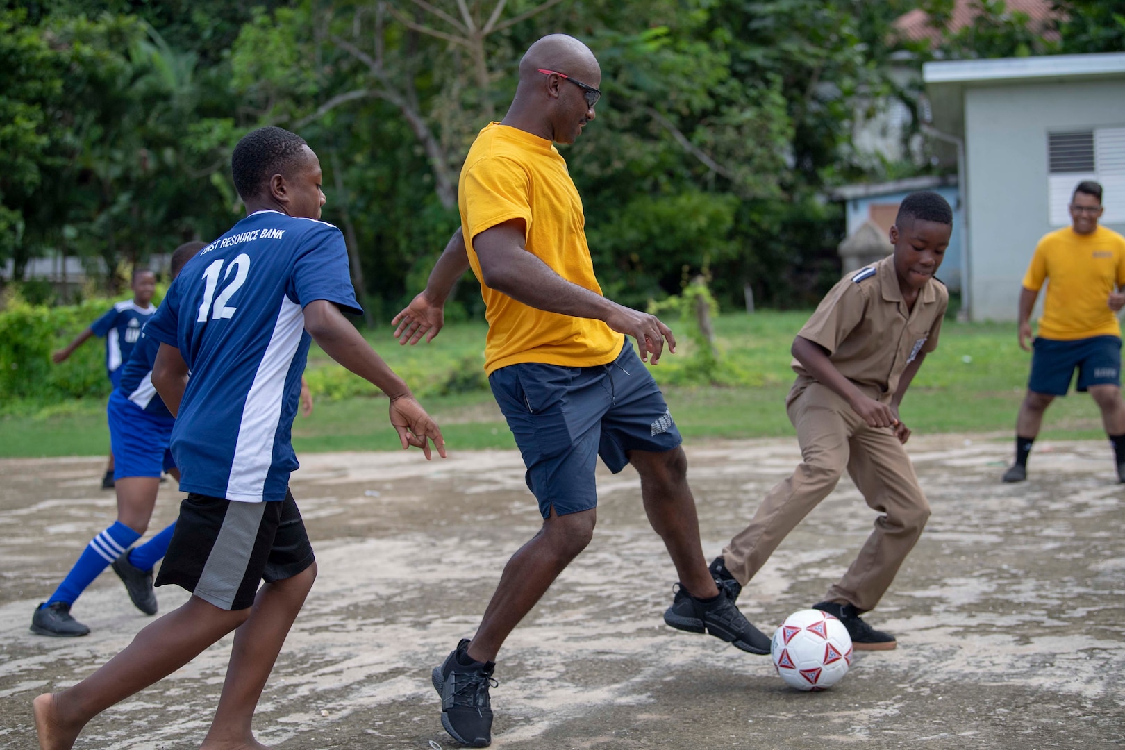 Sailors assigned to the Freedom-variant littoral combat ship USS Detroit (LCS 7) play soccer with students during a community relations event at Ocho Rios Primary School.