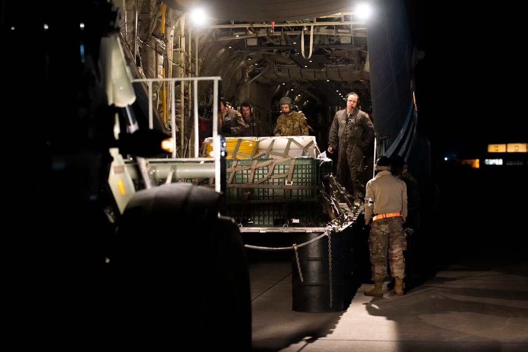 U.S. Airmen assigned to the 435th Contingency Response Squadron conduct combat offload method-B training at night during Exercise Agile Wolf at Ramstein Air Base, Germany, Dec. 17, 2019. Combat offload method-B allows the 37th Airlift Squadron to deploy cargo in austere locations without access to large mobility vehicles. (U.S. Air Force photo by Staff Sgt. Devin Nothstine)