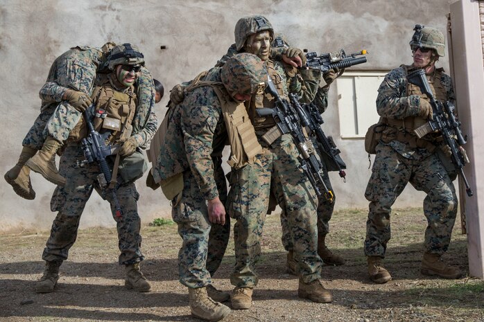 U.S. Marines carry simulated casualties after an assault through a combat town in the Tango Training Area during Steel Knight 20 at Marine Corps Base Camp Pendleton, California, Dec. 6.