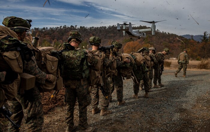 U.S. Marines and Soldiersprepare to board an MV-22B Osprey with Marine Medium Tiltrotor Squadron 262, during an insert as part of a comprehensive force on force event at Forest Light Middle Army in Aibano Training Area, Shiga, Japan, Dec. 10.