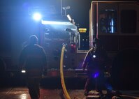 Firefighters check their fire truck Dec. 28, 2019, at Minot Air Force Base, North Dakota. The firefighters are unloading all of their gear from the truck in order to inspect the burning hangar. (U.S. Air Force Photos By Airman 1st Class Caleb S. Kimmell)