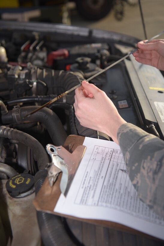 Staff Sgt. Garrison West, 100th Logistics Readiness Squadron mission generating vehicle equipment maintenance supervisor, checks the oil dipstick, Jan. 6, 2019, at RAF Mildenhall, England. 100th LRS vehicle maintenance shop can perform vehicle repairs from small body damage to a full replacement paint job, for more than 100 vehicles keeping them mission ready at all times. (U.S. Air Force photo by Senior Airman Alexandria Lee)