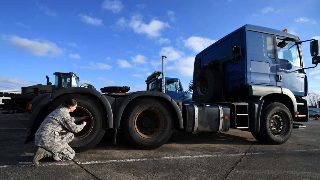 Staff Sgt. Garrison West, 100th Logistics Readiness Squadron mission generating vehicle equipment maintenance supervisor, checks the tire pressure of a semi-truck, Jan. 6, 2019, at RAF Mildenhall, England. The 100th LRS handles vehicle maintenance for RAF Mildenhall. (U.S. Air Force photo by Senior Airman Alexandria Lee)