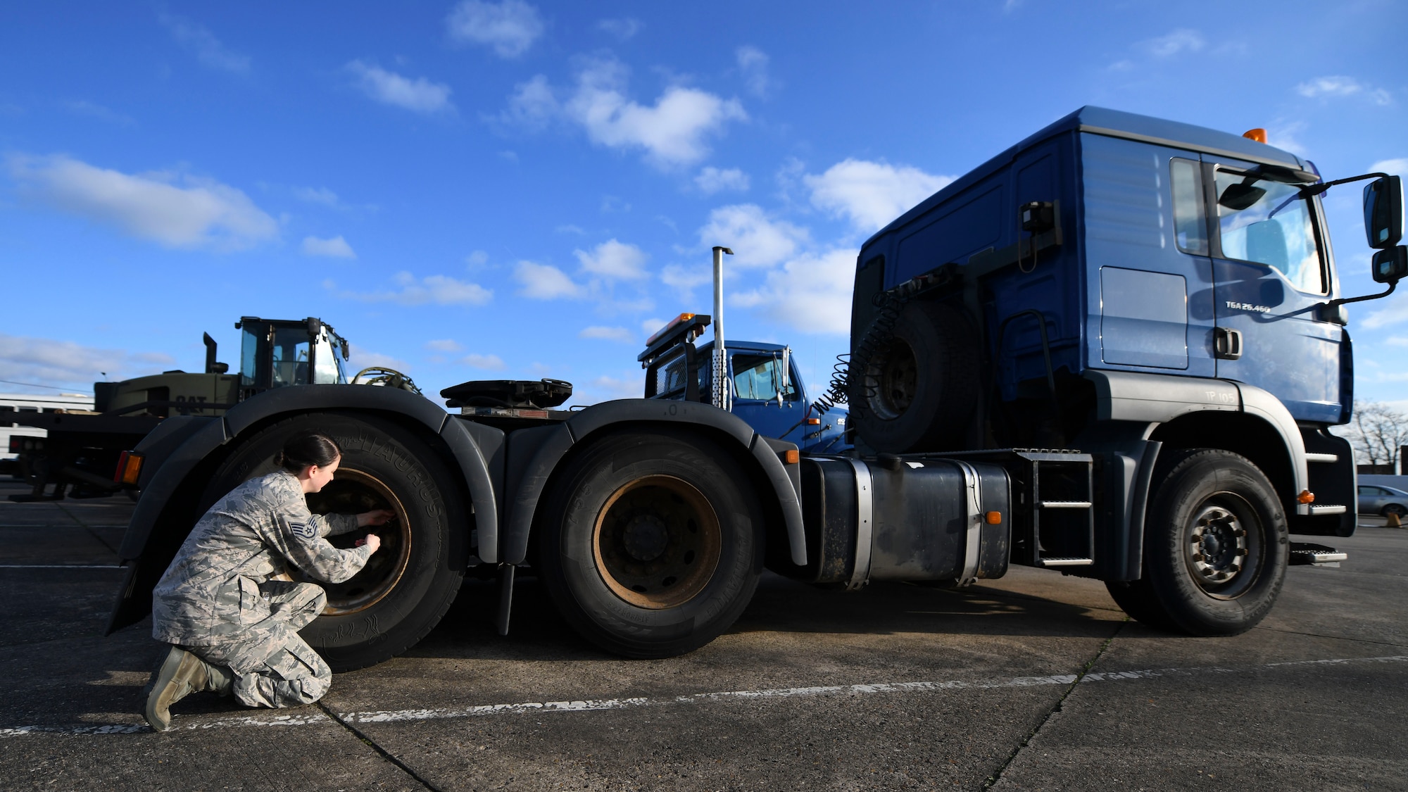 Staff Sgt. Garrison West, 100th Logistics Readiness Squadron mission generating vehicle equipment maintenance supervisor, checks the tire pressure of a semi-truck, Jan. 6, 2019, at RAF Mildenhall, England. The 100th LRS handles vehicle maintenance for RAF Mildenhall. (U.S. Air Force photo by Senior Airman Alexandria Lee)