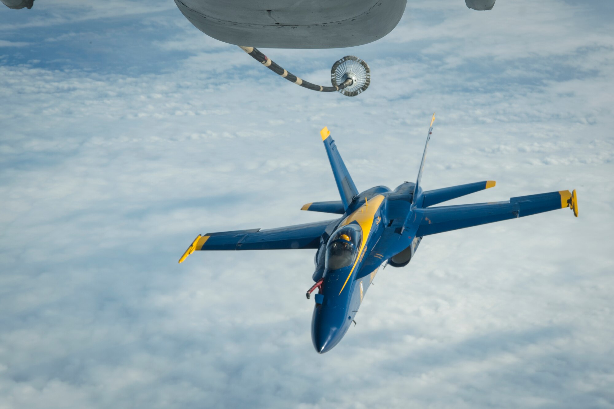 U.S. Navy Lt. Cmdr. Brandon Hempler, Blue Angels pilot, prepares to make contact with the drogue of a KC-10 Extender from the 78th Air Refueling Squadron, 514th Air Mobility Wing, Joint Base McGuire-Dix-Lakehurst, N.J., Jan. 3, 2020. The Blue Angels fly individually numbered McDonnell Douglas F/A-18 Hornets. Members from the 78th ARS flew a sortie to refuel the U.S. Navy Blue Angels as well as ship cargo from Travis Air Force Base, Calif., to Joint Base Pearl Harbor-Hickam, Hawaii. (U.S. Air Force photo by Senior Airman Ruben Rios)