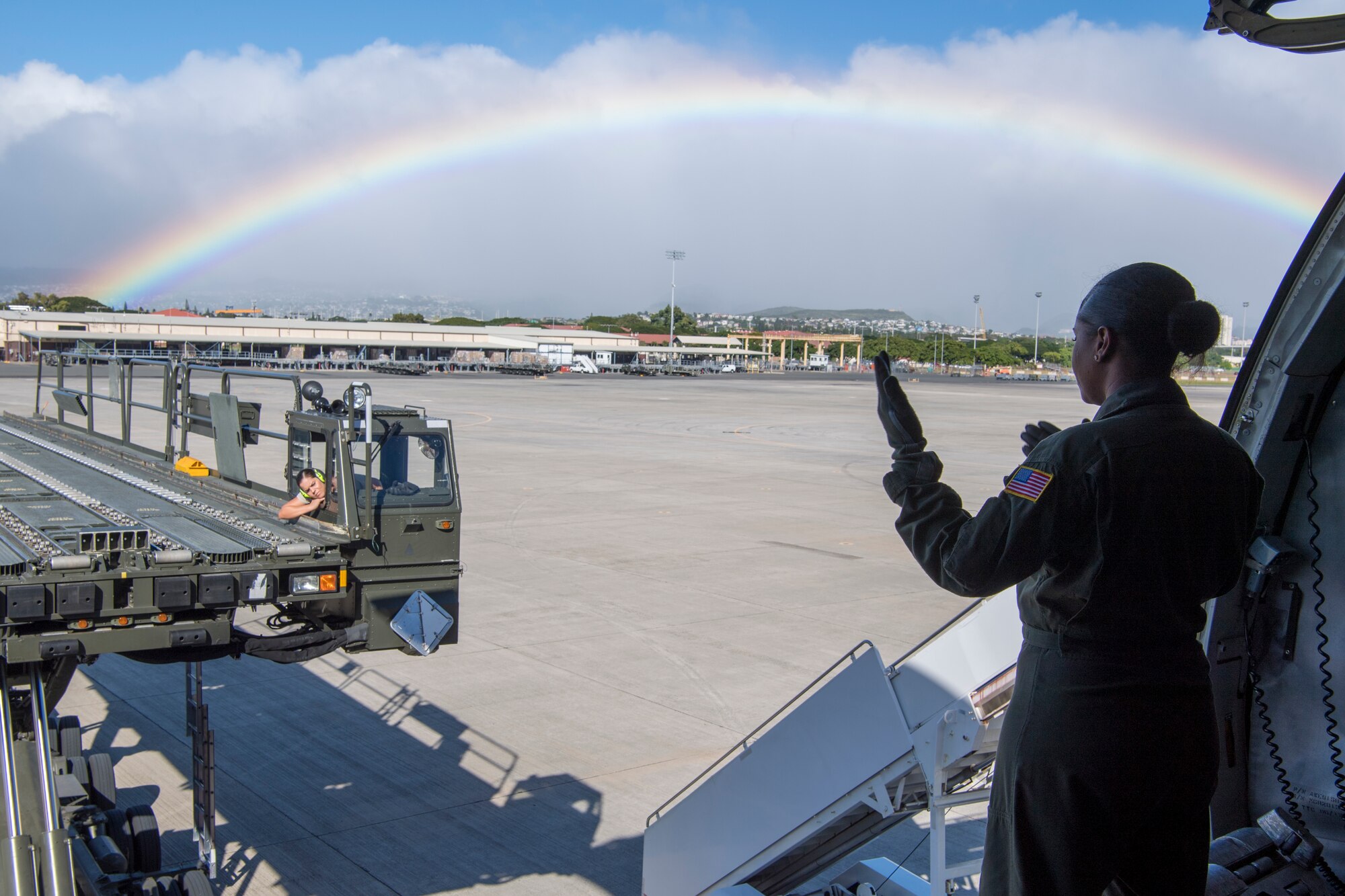 U.S. Air Force Staff Sgt. Jamila Lopez Daniel, a KC-10 Extender boom operator with the 78th Air Refueling Squadron, 514th Air Mobility Wing, guides a K-loader toward the door of the KC-10 to unload pallets of cargo at Joint Base Pearl Harbor-Hickam, Hawaii, Jan. 4, 2020. Members from the 78th ARS flew a sortie to refuel the U.S. Navy Blue Angels as well as ship cargo from Travis Air Force Base, Calif., to Joint Base Pearl Harbor-Hickam, Hawaii. (U.S. Air Force photo by Senior Airman Ruben Rios)