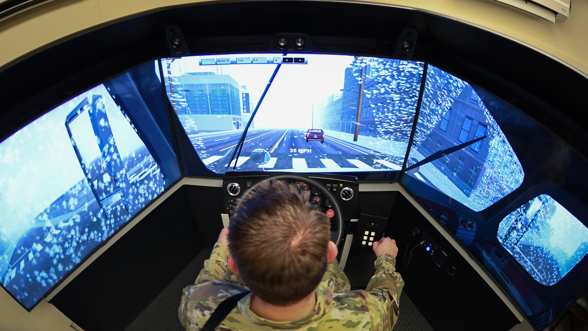 Staff Sgt. Andrew Bagley, training validation and operation NCOIC for the 75th Logistics Readiness Squadron, practices driving in rain on the unit's new vehicle training simulator.  Drivers can use the state-of-the-art simulator to practice on about 30 different vehicles in nearly every driving condition imaginable.   (U.S. Air Force photos by Cynthia Griggs)