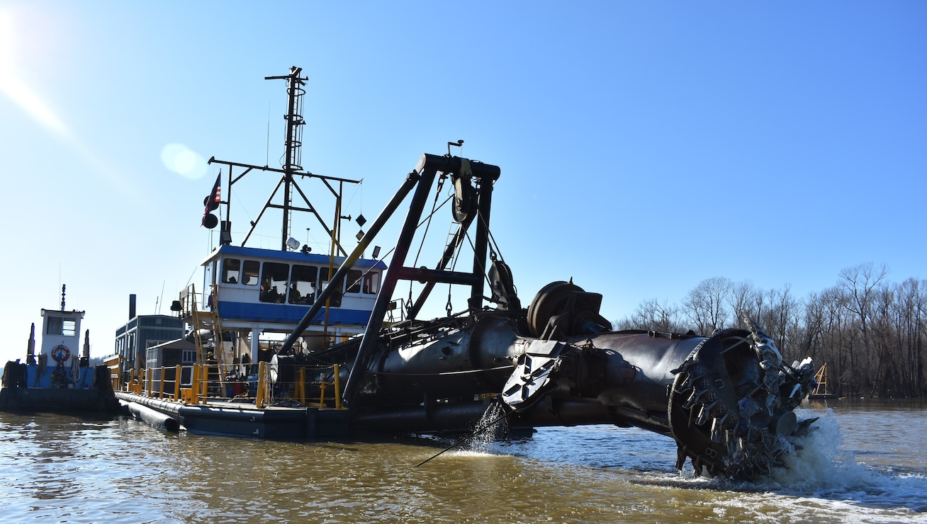 IN THE PHOTO, the Inland Dredging Company’s cutterhead dredge “Integrity,” along with one of its small tugboats, works to dredge the Memphis Harbor/McKellar Lake, which was the last of 10 harbors dredged in the Memphis District during 2019. (USACE photo/Jessica Haas)