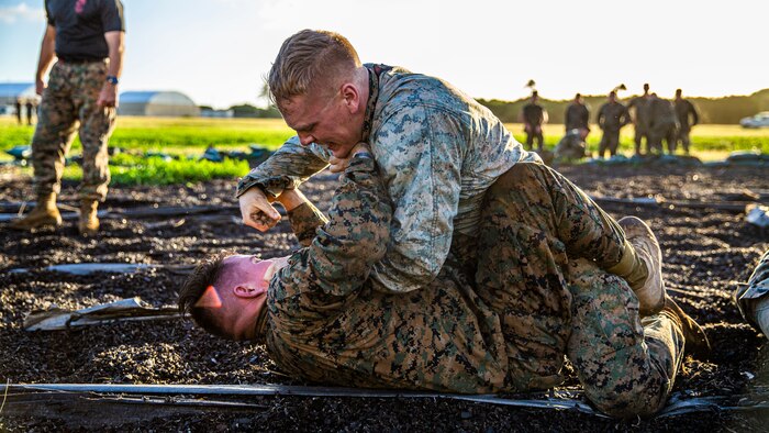 U.S. Marine Corps Lance Cpl. Keegan McNew and Cpl. Neftaly Jordan, 3rd Marine Regiment, grapple during a regimental squad competition on Marine Corps Base Hawaii, Dec. 19.