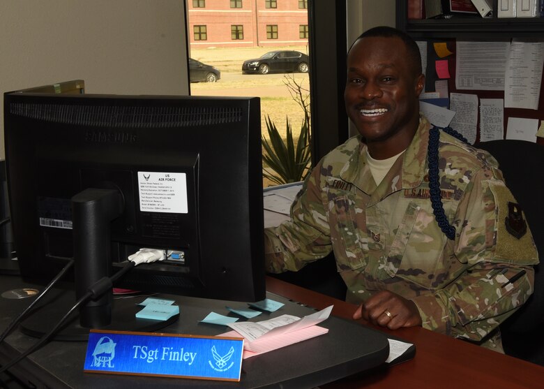 U.S. Air Force Tech. Sgt. Derwin Finley, 315th Training Squadron military training leader, smiles at his desk in the 316th TRS MTL office on Goodfellow Air Force Base, Texas, Dec. 13, 2019. Finley has been assigned to Goodfellow for two years and has been enlisted in the Air Force for 12 years. (U.S. Air Force photo by Airman 1st Class Abbey Rieves)