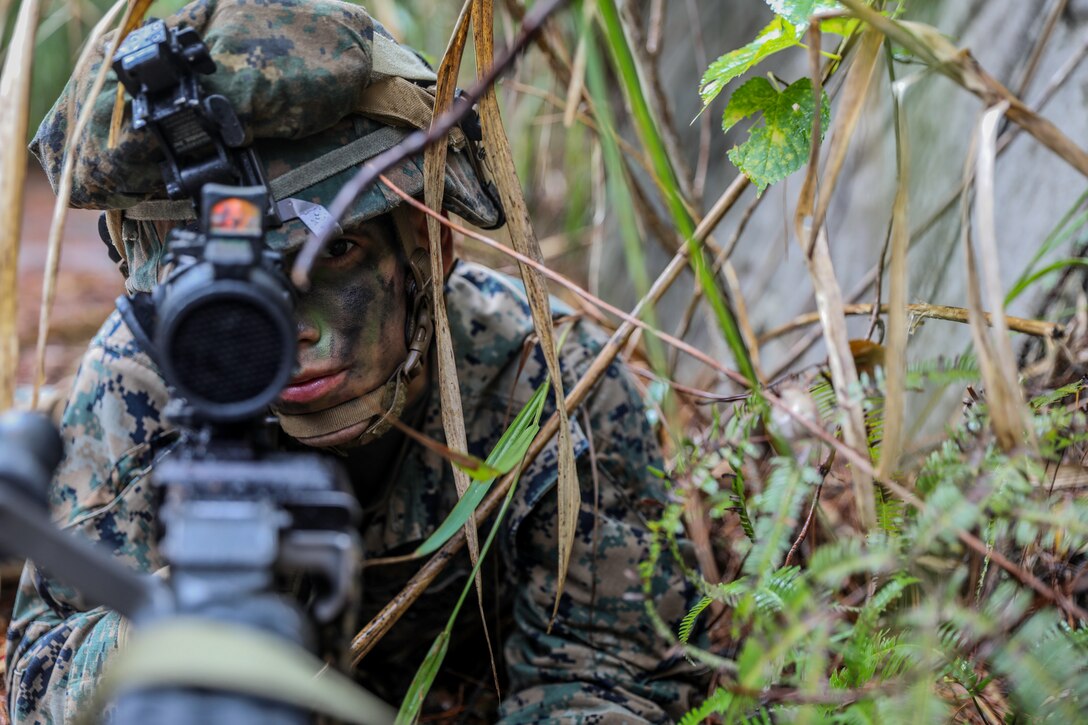 U.S. Marine Corps Lance Cpl. Kristopher Reyes posts security during a reconnaissance patrol on Camp Hansen, Okinawa, Japan, Dec. 11.