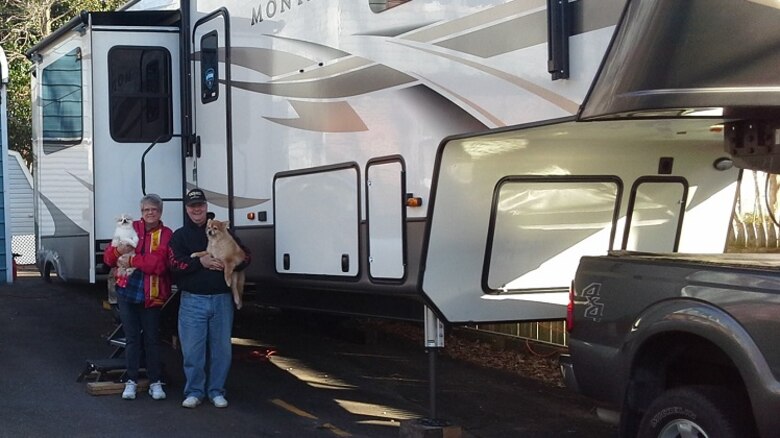 Retired Marine Corps Master Sgt. Tommy "TJ" Pittman and his wife, Sheila, pose with their two dogs, Nugget and Snickers, in front of their new recreational vehicle, which will be used for post-retirement adventures. Pittman served the amphibious assault community for nearly 50 years, first as an enlisted amphibious vehicle operator for 24 years, then as a logistician with the Advanced Amphibious Assault program office at Program Executive Officer Land Systems for another 24 years. Pittman retired from federal civil service in December 2019. (Courtesy photo from Tommy Pittman)
