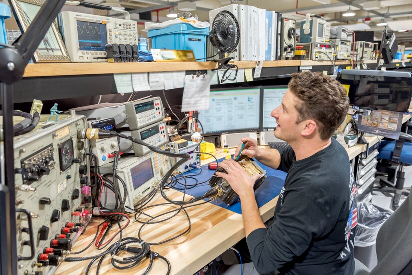 Photo of Frank Gervasi testing electronic equipment