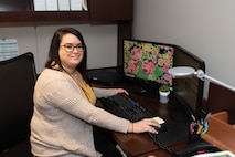 Photo of Melia Smirne sitting at her desk