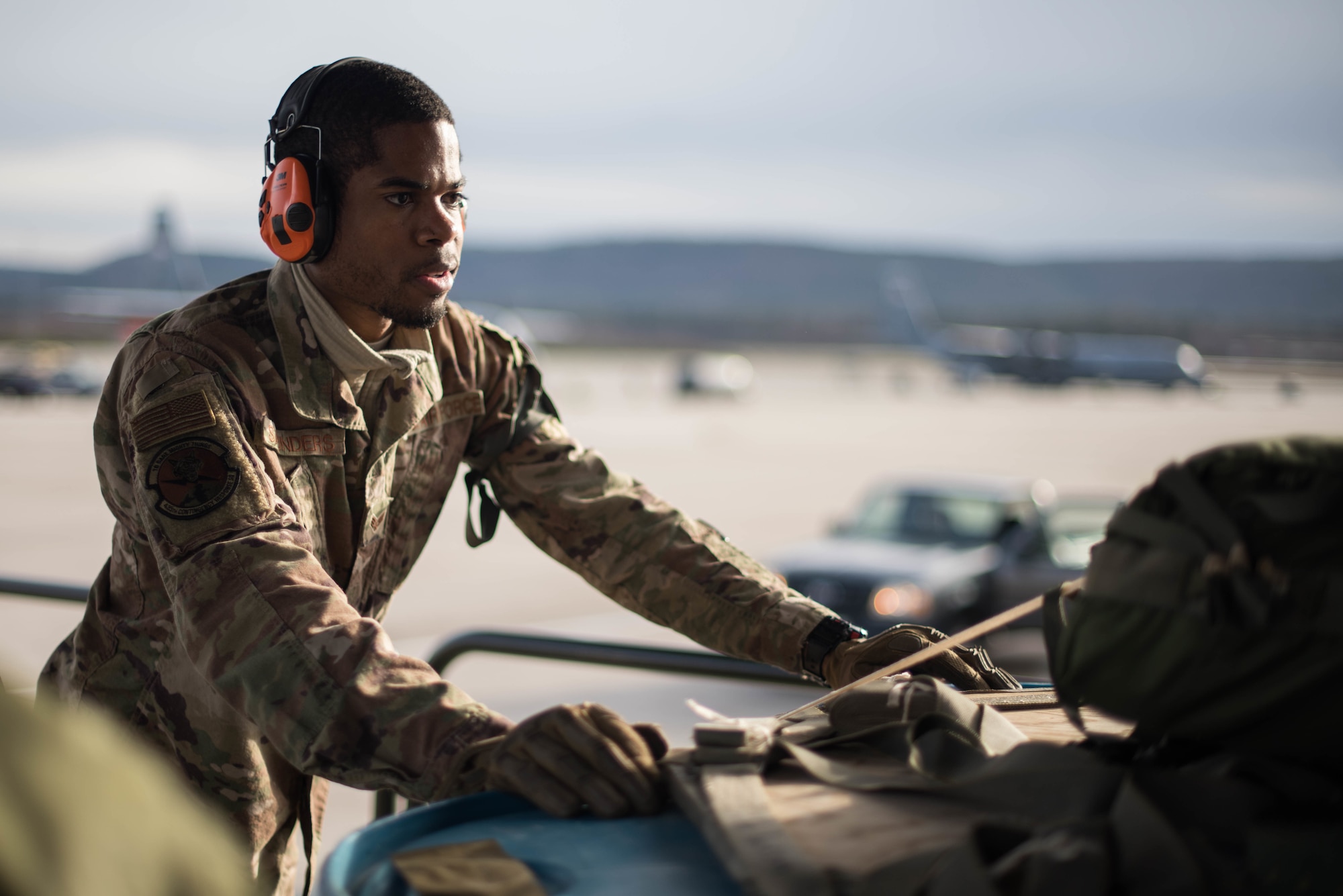 U.S. Air Force Senior Airman Kenneth Saunders, 435th Contingency Response Squadron mobile aerial porter, pushes a pallet onto a C-130J Super Hercules aircraft during Exercise Agile Wolf at Ramstein Air Base, Germany, Dec. 17, 2019. The 435th provides U.S. Air Forces in Europe's primary expeditionary aerial port capability and performs initial airfield operations enabling rapid standup of combat operations anywhere in the European region. (U.S. Air Force photo by Staff Sgt. Devin Nothstine)