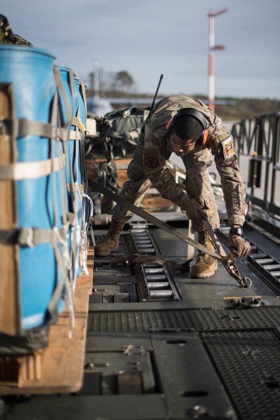U.S. Air Force Senior Airman Kenneth Saunders, 435th Contingency Response Squadron mobile aerial porter, secures a pallet during Exercise Agile Wolf at Ramstein Air Base, Germany, Dec. 17, 2019. The 435th provides U.S. Air Forces in Europe's primary expeditionary aerial port capability and performs initial airfield operations enabling rapid standup of combat operations anywhere in the European theater. (U.S. Air Force photo by Staff Sgt. Devin Nothstine)