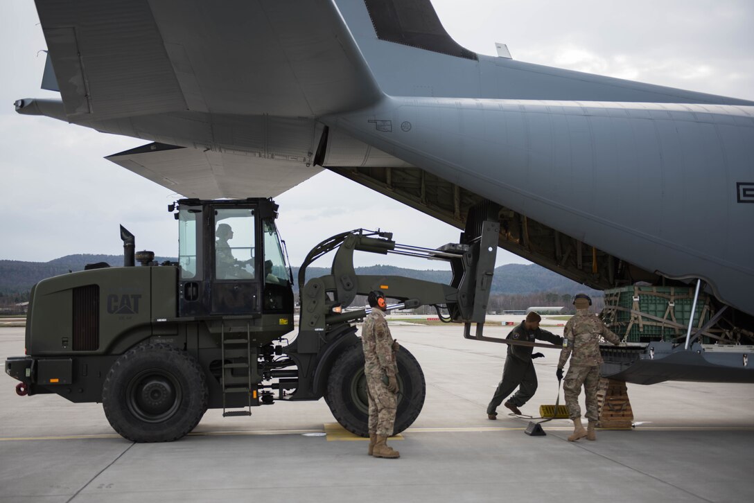 U.S. Air Force Airmen assigned to the 435th Contingency Response Squadron load small cargo pallets onto a 37th Airlift Squadron C-130J Super Hercules aircraft during Exercise Agile Wolf at Ramstein Air Base, Germany, Dec. 17, 2019. Agile Wolf tests the 435th CRS’s ability to coordinate and operate mobility operations with the 37th AS for the first time at Ramstein Air Base. (U.S. Air Force photo by Staff Sgt. Devin Nothstine)