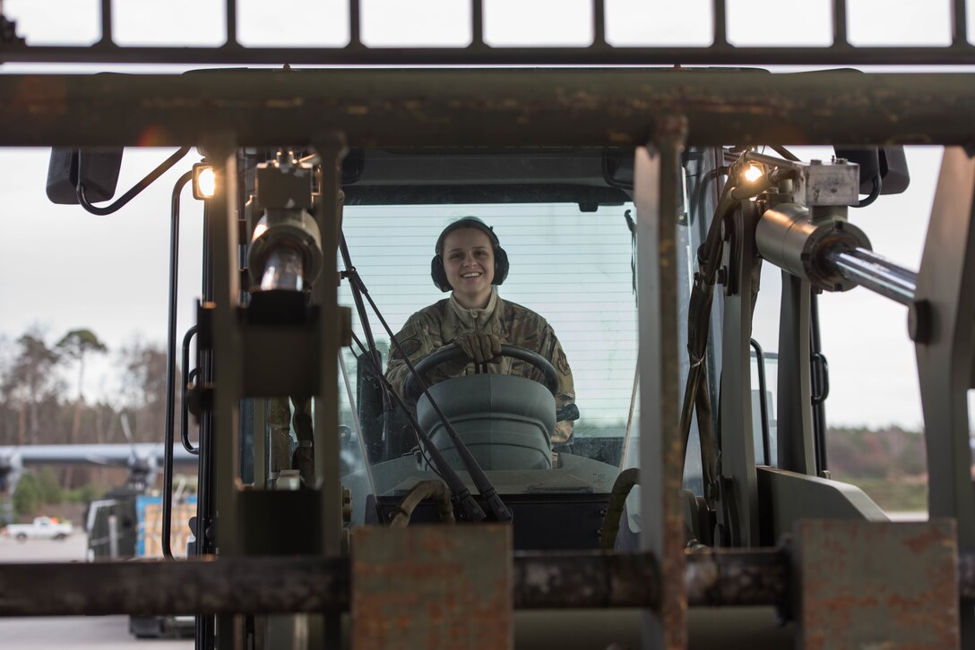U.S. Air Force Airman First Class Cecilia Bak, 435th Contingency Response Squadron mobile aerial porter, smiles after loading a C-130J Super Hercules aircraft during Exercise Agile Wolf at Ramstein Air Base, Germany, Dec. 17, 2019. The 435th provides U.S. Air Forces in Europe's primary expeditionary aerial port capability and performs initial airfield operations enabling rapid standup of combat operations anywhere in the European theater. (U.S. Air Force photo by Staff Sgt. Devin Nothstine)