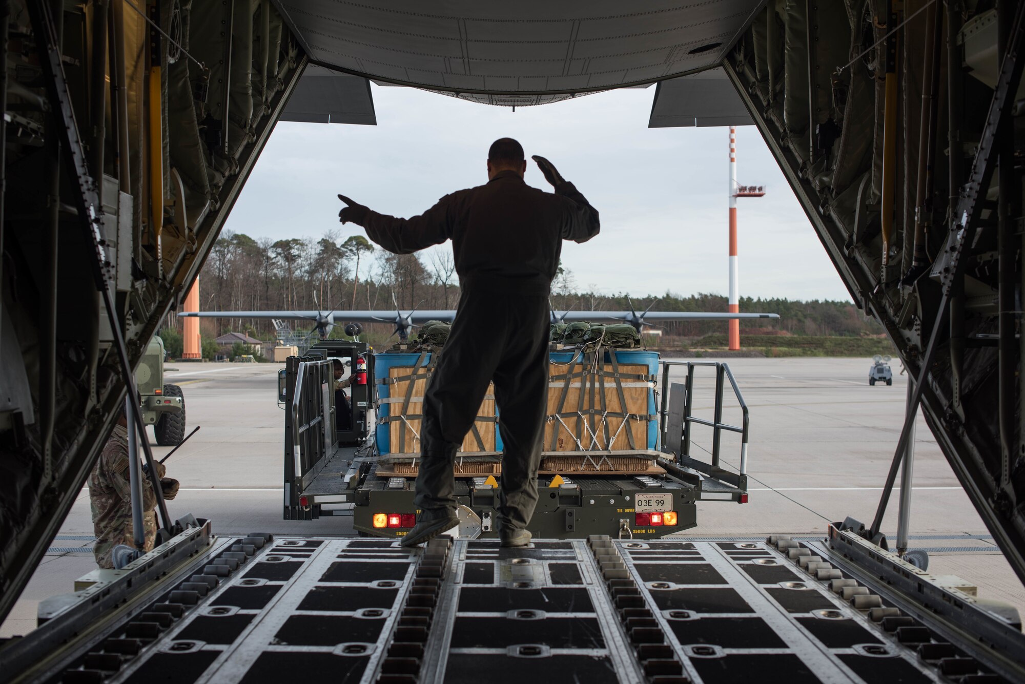 A U.S. Air Force Airman assigned to the 37th Airlift Squadron guides a mobile aerial porter before loading a C-130J Super Hercules aircraft during Exercise Agile Wolf at Ramstein Air Base, Germany, Dec. 17, 2019. Agile Wolf tests the 435th CRS’s ability to coordinate and operate mobility operations with the 37th AS for the first time at Ramstein Air Base. (U.S. Air Force photo by Staff Sgt. Devin Nothstine)