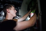 SANTA RITA, Guam (Jan. 3, 2020) Culinary Specialist (Submarine) Seaman William Minge, from Lebanon, Ohio, stores cans of food in the auxiliary tank during an onload of provisions aboard the Los Angeles-class fast attack submarine USS Key West (SSN 722). Key West is one of four forward-deployed submarines assigned to Commander, Submarine Squadron Fifteen out of Polaris Point, Guam.