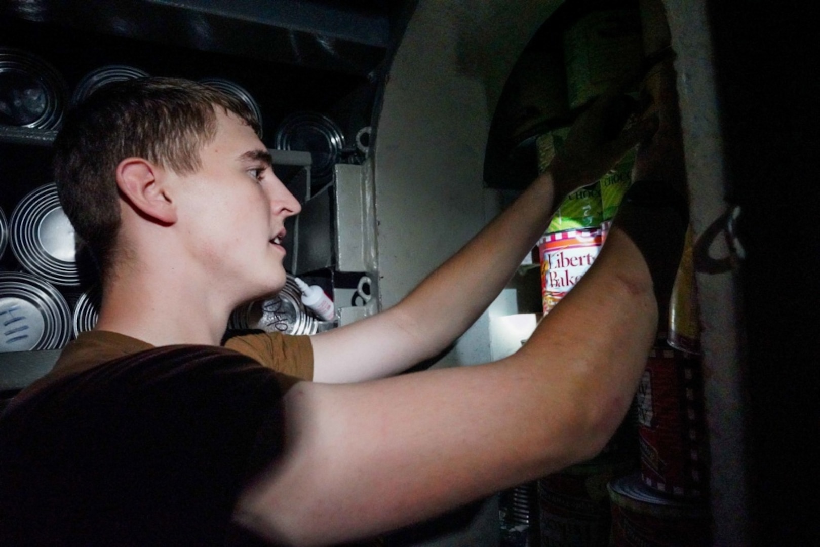 SANTA RITA, Guam (Jan. 3, 2020) Culinary Specialist (Submarine) Seaman William Minge, from Lebanon, Ohio, stores cans of food in the auxiliary tank during an onload of provisions aboard the Los Angeles-class fast attack submarine USS Key West (SSN 722). Key West is one of four forward-deployed submarines assigned to Commander, Submarine Squadron Fifteen out of Polaris Point, Guam.