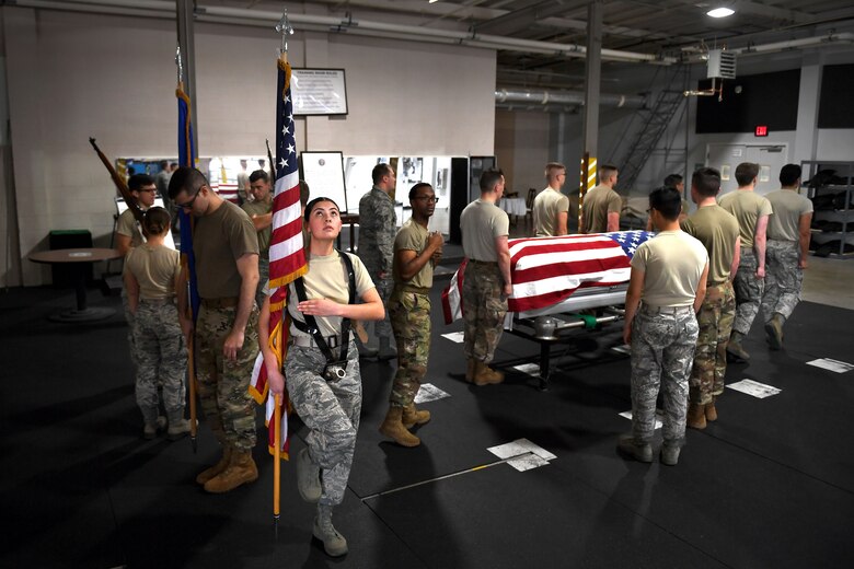 People work in an honor guard bay.