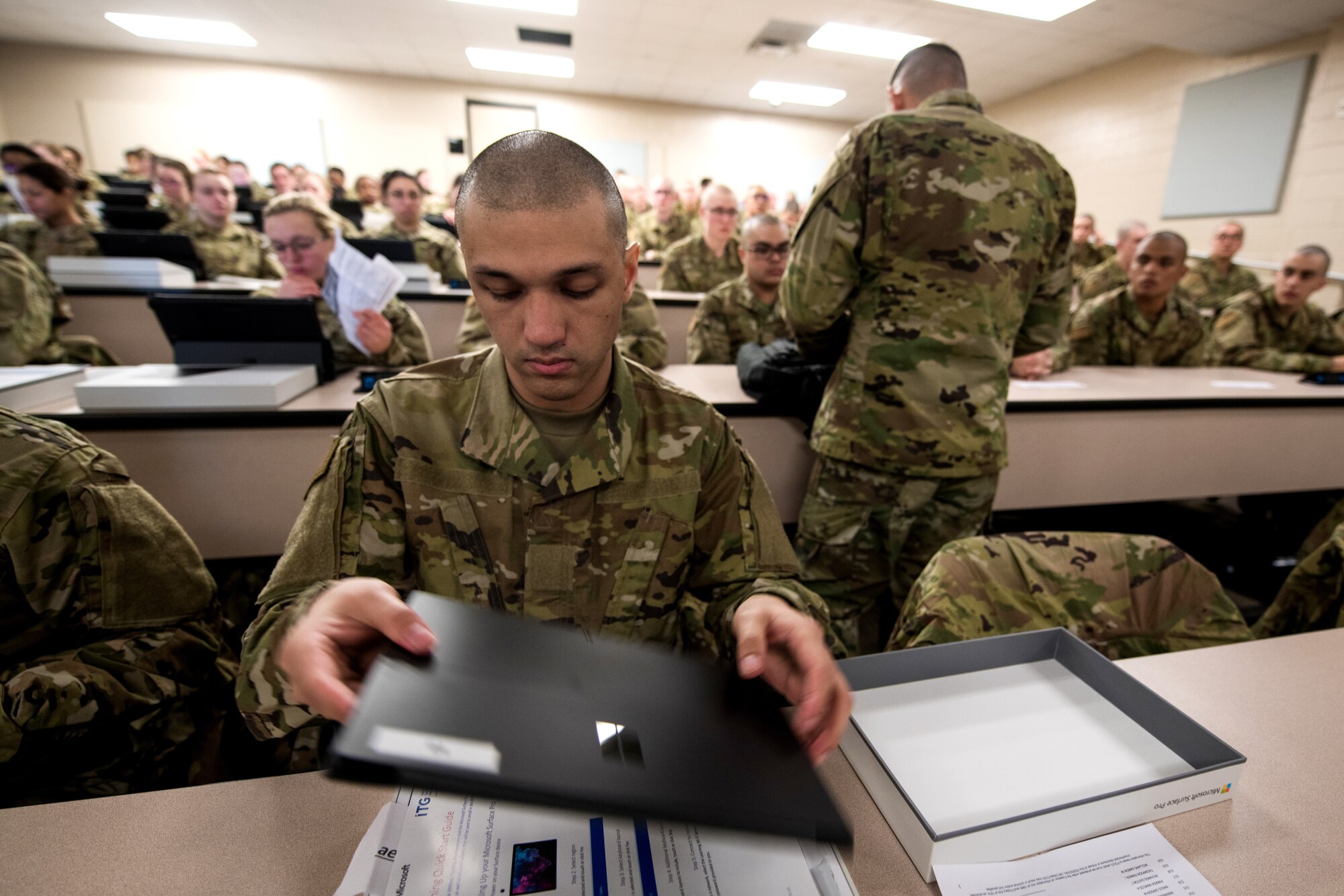 U.S. Air Force basic military training trainees are issued personal computers during in-processing as part of a pilot test under a Cooperative Research and Development Agreement partnership at Joint Base San Antonio-Lackland, Texas, Dec. 11, 2019. The computers replace all hard copy textbooks BMT trainees currently use with the intent to help BMT assess learning outcomes, value and return on investment. (U.S. Air Force photo by Sarayuth Pinthong)