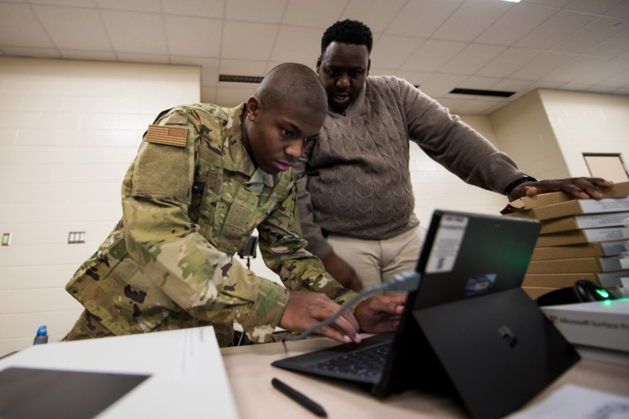 U.S. Air Force basic military training trainees are issued personal computers during in-processing as part of a pilot test under a Cooperative Research and Development Agreement partnership at Joint Base San Antonio-Lackland, Texas, Dec. 11, 2019. The computers replace all hard copy textbooks BMT trainees currently use with the intent to help BMT assess learning outcomes, value and return on investment. (U.S. Air Force photo by Sarayuth Pinthong)