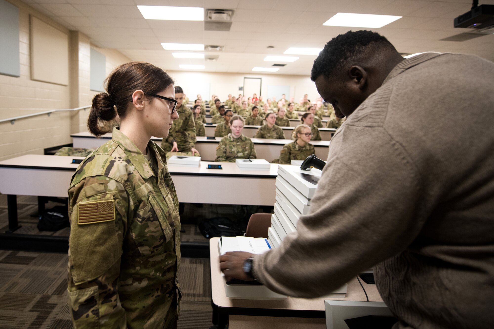 U.S. Air Force basic military training trainees are issued personal computers during in-processing as part of a pilot test under a Cooperative Research and Development Agreement partnership at Joint Base San Antonio-Lackland, Texas, Dec. 11, 2019. The computers replace all hard copy textbooks BMT trainees currently use with the intent to help BMT assess learning outcomes, value and return on investment. (U.S. Air Force photo by Sarayuth Pinthong)