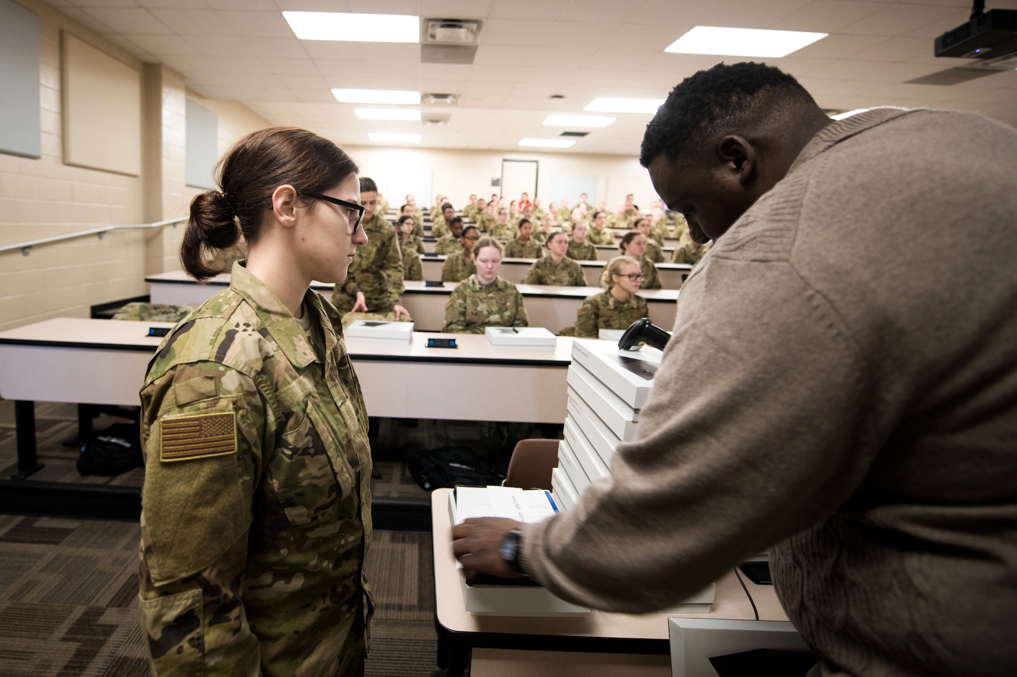 U.S. Air Force basic military training trainees are issued personal computers during in-processing as part of a pilot test under a Cooperative Research and Development Agreement partnership at Joint Base San Antonio-Lackland, Texas, Dec. 11, 2019. The computers replace all hard copy textbooks BMT trainees currently use with the intent to help BMT assess learning outcomes, value and return on investment. (U.S. Air Force photo by Sarayuth Pinthong)