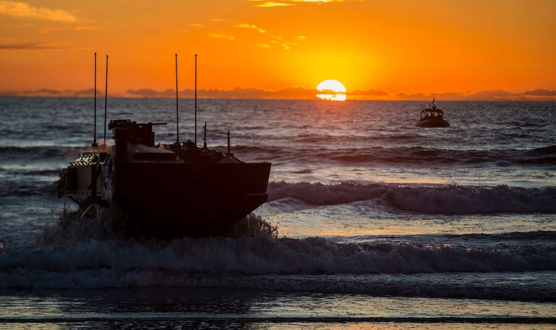 U.S. Marines with Amphibious Vehicle Test Branch, Marine Corps Tactical Systems Support Activity, drive a new Amphibious Combat Vehicle ashore during low-light surf transit testing at AVTB Beach on Marine Corps Base Camp Pendleton, California, Dec. 18.