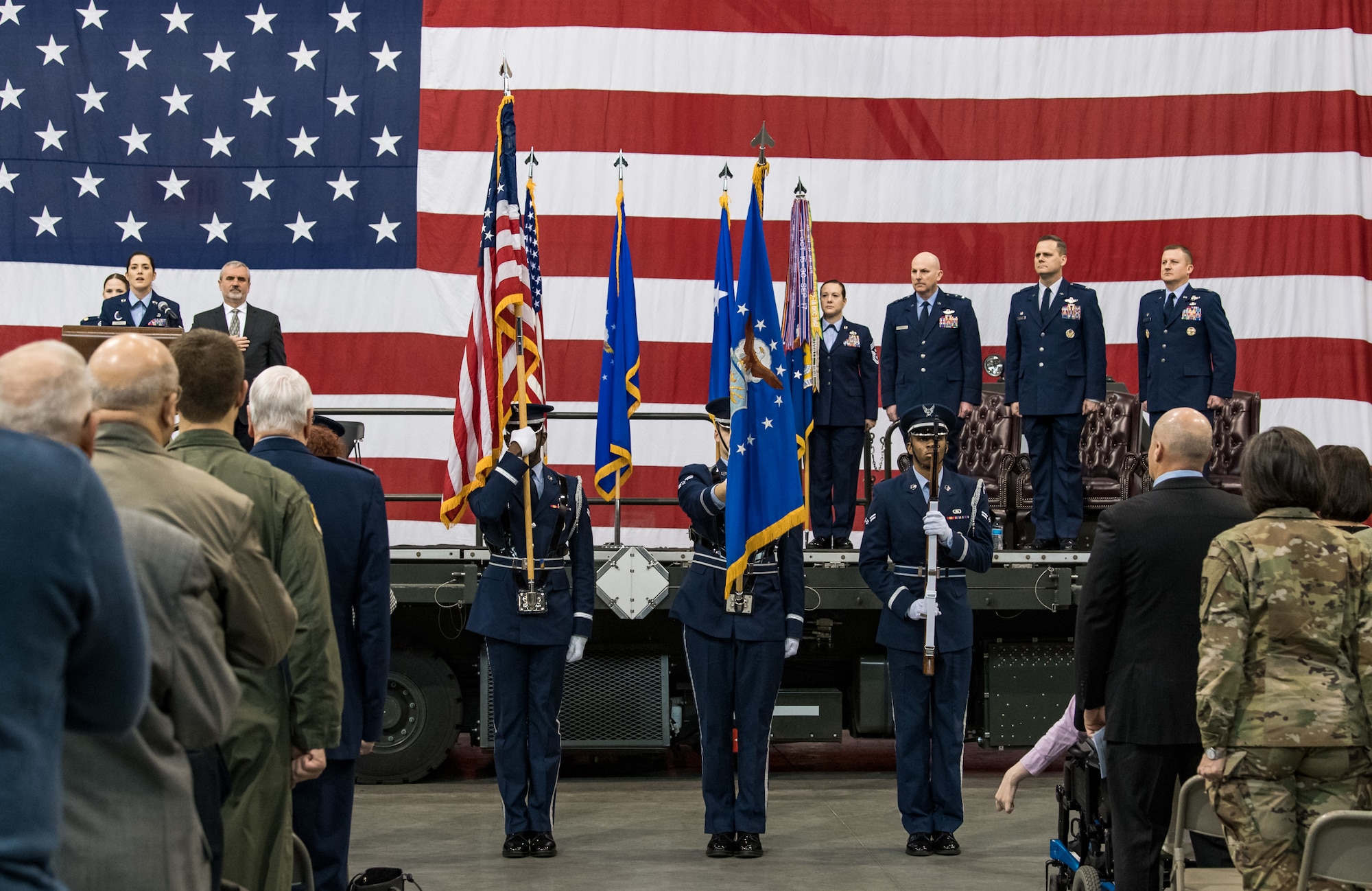 The 436th Airlift Wing Honor Guard posts the colors during the 436th AW Change of Command Jan. 7, 2020, inside the 436th Aerial Port Squadron, on Dover Air Force Base, Del. Staff Sgt. Alicia Garcia, 436th Force Support Squadron Airman Leadership School instructor, performed the national anthem during the ceremony. (U.S. Air Force photo by Roland Balik)