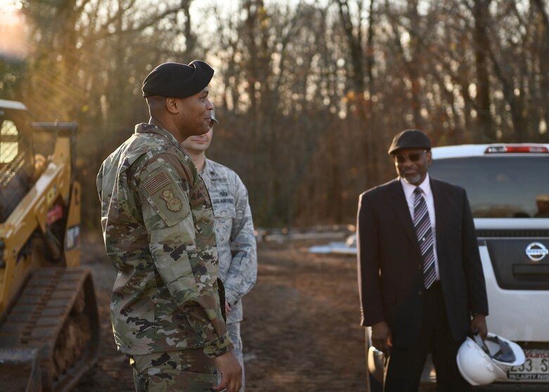 An Airman looks at a building.