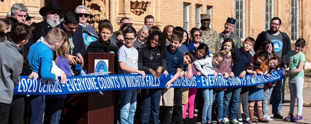 Wichita Falls Mayor Stephen Santellana cuts a ribbon at the 2020 Census launch event at the Memorial Auditorium in Wichita Falls, Texas, Jan. 7, 2020. After the speeches at the event, attendees of the event counted down as Santellana and fourth grade WFISD students officially cut the 2020 census ribbon to kick-off the count phase. (U.S. Air Force photo by Senior Airman Pedro Tenorio)