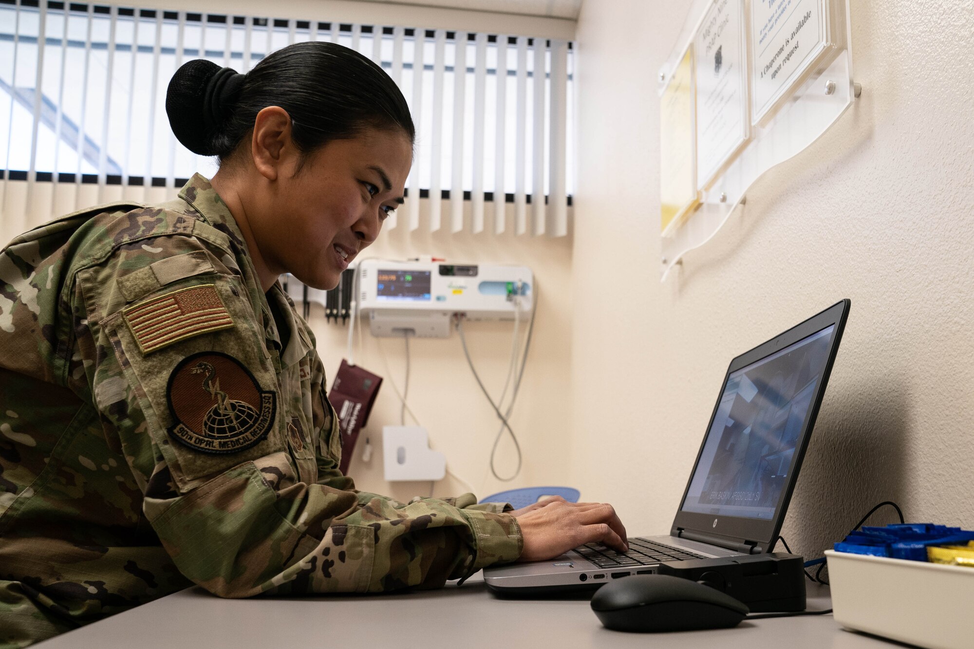 Master Sgt. Renelyn Pagan, Operational Medicine flight chief, 90th Operations Medical Readiness Squadron, and 2nd Lt. Erik Baskin, Systems Flight commander, 90th Health Care Operations Squadron,demonstrate how the new video medical care system will work. Maj. Michael Vernale, Mental Health Flight commander worked with the 90th Missile Wing LaunchWERX agency to launch the idea as part of an ongoing effort to innovate the Air Force to meet the demands of tomorrow. The plan is to install the capability in each missile alert facility. (U.S. Air Force photo by Joseph Coslett)