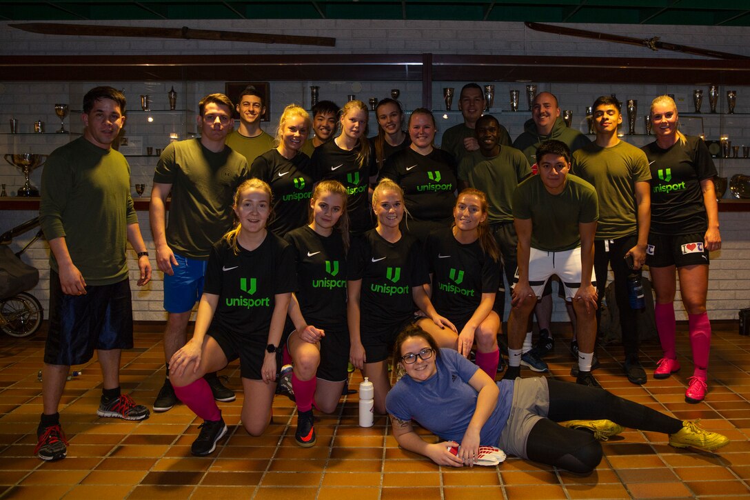 U.S. Marines with Marine Rotational Force-Europe 20.1, Marine Forces Europe and Africa, pose for a picture with a local Bardu soccer team during the Juleturneringa in Setermoen, Norway, Dec. 28, 2019. An invitation to an annual Christmas tournament exclusive to former and present Bardu soccer players was extended to Marines to provide them an opportunity to engage in local culture. MRF-E focuses on regional engagements throughout Europe by conducting various exercises, arctic cold-weather and mountain-warfare training, and military-to-military engagements, which enhance overall interoperability of the U.S. Marine Corps with allies and partners. (U.S. Marine Corps photo by Sgt. Justin X. Toledo)