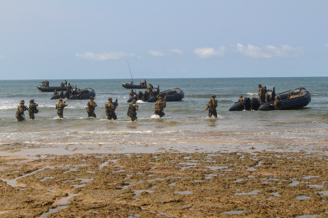 U.S. Marines with Special Purpose Marine Air-Ground Task Force-Crisis Response-Africa 20.1, Marine Forces Europe and Africa, and Belgian Army soldiers with the Special Operations Regiment withdraw from the beach during an amphibious landing demonstration during the closing ceremonies for Exercise Tropical Storm in Akanda, Gabon, Dec. 15, 2019.