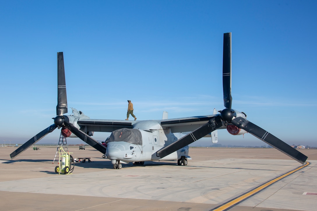 A U.S. Marine with Special Purpose Marine Air-Ground Task Force-Crisis Response-Africa 20.1, Marine Forces Europe and Africa, walks across on top of an MV-22 Osprey at Morón Air Base, Spain, Dec. 30, 2019