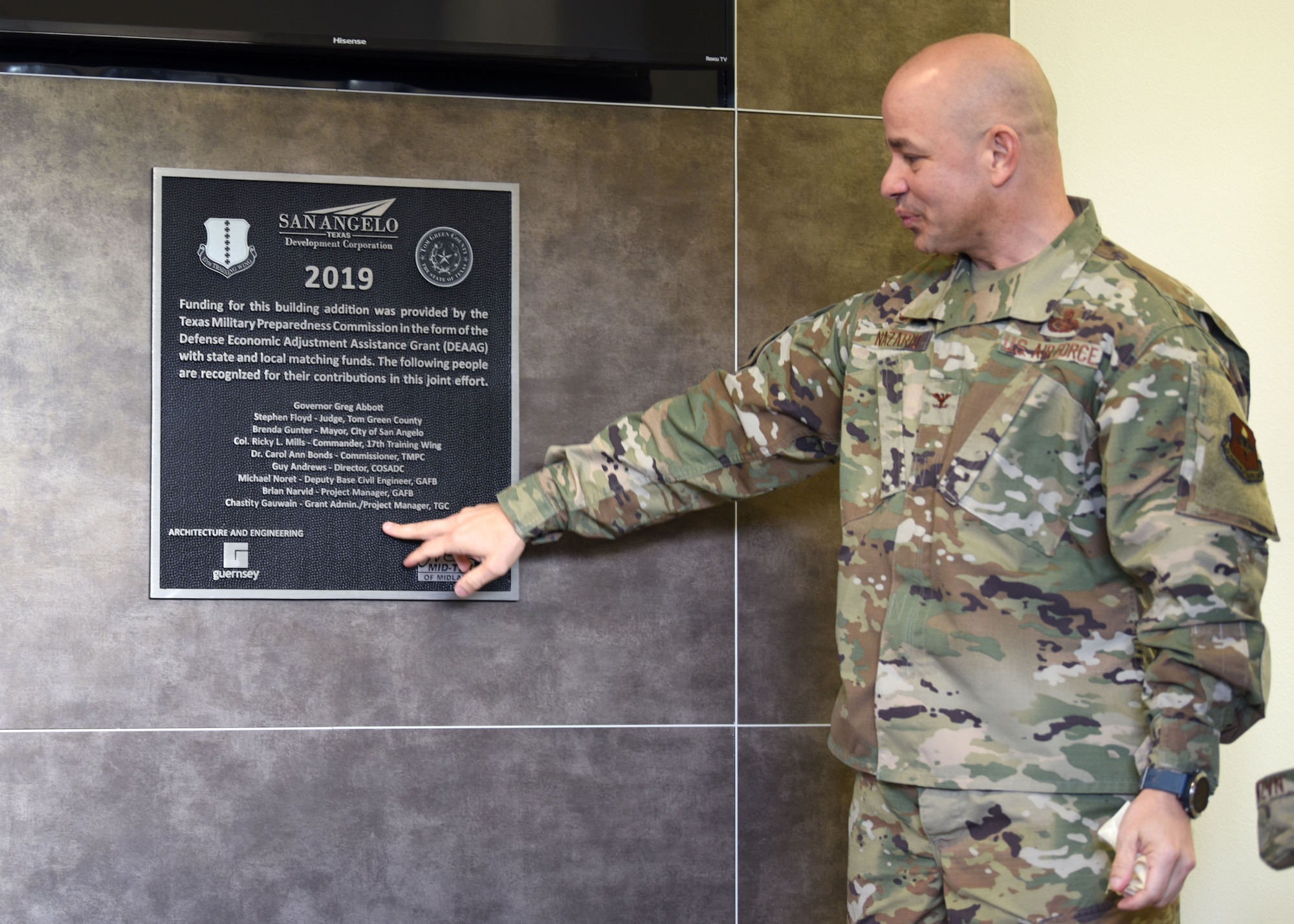 U.S. Air Force Col. Andres Nazario, 17th Training Wing commander, unveils a dedication plaque at the Cressman Dining Facility on Goodfellow Air Force Base, January 6, 2020. The plaque listed the names of the individuals who helped create the new multi-purpose facility. (U.S. Air Force photo by Airman 1st Class Ethan Sherwood)