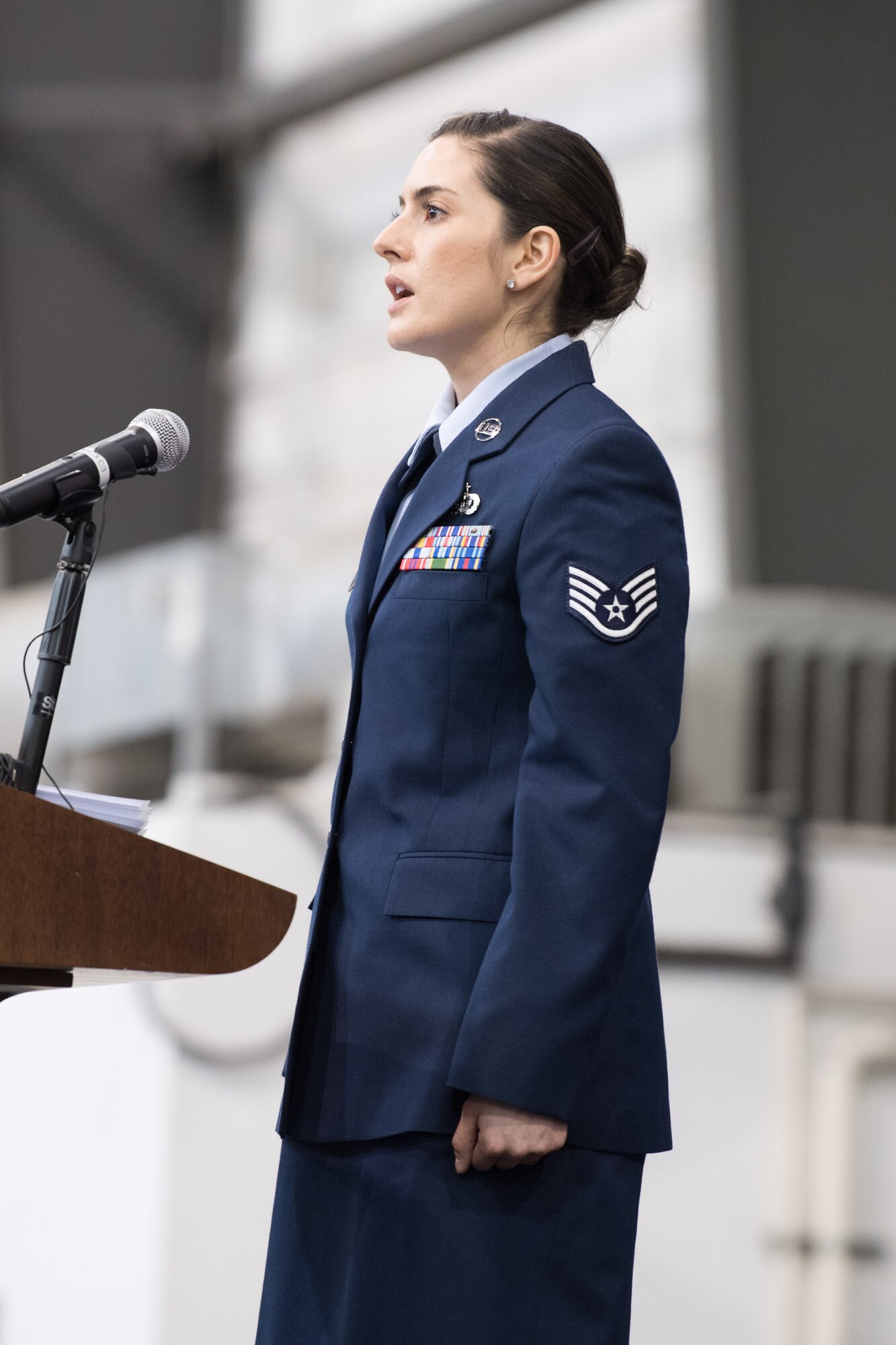 Staff Sgt. Alicia Garcia, 436th Force Support Squadron Advanced Leadership School instructor, sings the national anthem during the 436th AW Change of Command ceremony Jan 7, 2020, at Dover Air Force Base, Del. Col. Joel Safranek relinquished command to Col. Matthew Jones in a ceremony officiated by 18th Air Force commander Maj. Gen. Sam C. Barrett. (U.S. Air Force photo by Mauricio Campino)