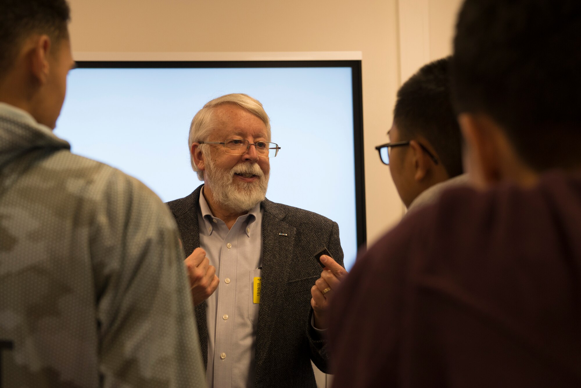Jay Simpson, former Technical Director and Program Manager for the CIA, meets with students for hands-on activities during an educational event hosted by the Air Force Association and Kaiserslautern High School Science, Technology, Engineering and Mathematics program at Kapaun Air Station, Germany, Dec. 16, 2020. Simpson wrote several books on optical fiber technology and is responsible for 80 publications and 15 patents in the field.